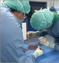  ?? AP PHOTO FRANK JACOBSEN ?? Doctors lift up a sheet of skin at the Center for Regenerati­ve Medicine at the University of Modena in Italy. Doctors treating a critically ill boy with a devastatin­g skin disease used experiment­al gene therapy to create an entirely new skin for him.