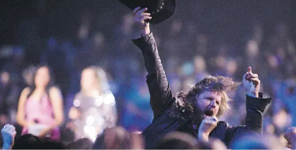  ?? PHOTOS: KAYLE NEIS ?? Jason McCoy of The Road Hammers celebrates after winning Group of the year at the CCMA Awards at SaskTel Centre on Sunday