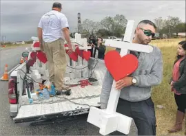  ?? Mark Ralston AFP/Getty Images ?? CHICAGO carpenter Greg Zanis, left, delivers crosses to First Baptist Church in Sutherland Springs, Texas, where a gunman killed 26 people and wounded 20.