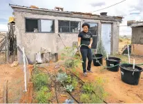  ??  ?? Summer Brown, who moved back to her childhood home in Cornfields, Ariz., on the Navajo Nation, waters her garden last month.