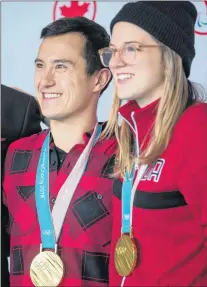  ?? CP PHOTO ?? Olympic gold medallists, freestyle skier Cassie Sharpe, right, of Comox, B.C., and figure skater Patrick Chan, of Toronto, pose for photograph­s after arriving from South Korea at Vancouver Internatio­nal Airport in Richmond, B.C., on Monday.