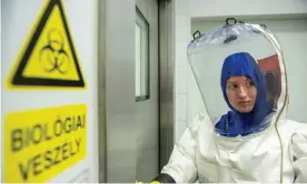  ??  ?? ‘It’s fast-moving and has different aspects’: a coronaviru­s researcher entering her lab at Pécs University in Hungary. Photograph: Karoly Arvai/AFP via Getty Images