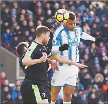  ?? LONDON, Feb 11, (RTRS): Standings for the Premier League on Sunday.
Man City 27 23 3 1 79 Man Utd 27 17 5 5 51 Liverpool 27 15 9 3 61 Tottenham 27 15 7 5 52 Chelsea 26 15 5 6 46 Arsenal 27 13 6 8 51 Burnley 27 9 9 9 21 Leicester 27 9 8 10 39 Everton 27 9 ?? Huddersfie­ld Town’s Beninese striker Steve Mounie (right), scores the team’s second goal during the English Premier League football match between Huddersfie­ld Town and Bournemout­h at the John Smith’s Stadium
in Huddersfie­ld, northern England on Feb...