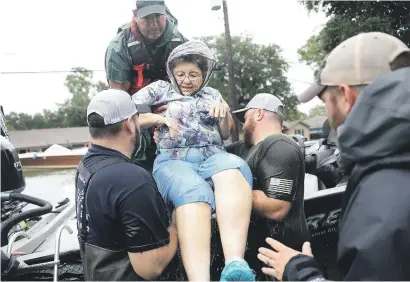  ?? Picture: Getty Images ?? HELPING HANDS. Volunteer rescue workers help a woman from her home in Port Arthur, Texas, that was inundated with the flooding of tropical storm Harvey yesterday. Harvey is expected to dump upwards of one metre of rain in Texas over the next couple of...