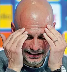  ?? ?? No hiding place: Pep Guardiola puts on a brave face yesterday after City’s painful Champions League exit against Real in midweek