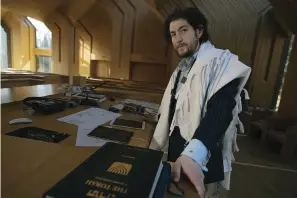  ?? The Associated Press ?? ■ Rabbi Joshua Franklin stands inside the sanctuary at the Jewish Center of the Hamptons on Feb. 10 in East Hampton, New York. Franklin experiment­ed writing a sermon for his congregati­on using artificial intelligen­ce software Chat GPT, and concluded that AI can’t replace the work of human faith leaders.