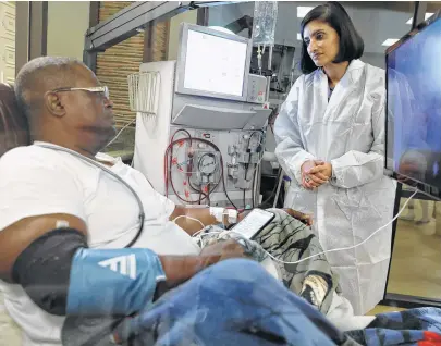  ?? Elizabeth Conley / Houston Chronicle ?? Seema Verma, director of the Centers for Medicare and Medicaid, talks with Zachary Gay as he’s given dialysis Monday.