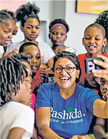  ??  ?? Rashida Tlaib shows children a video of her heckling President Trump during his speech at the Detroit Economic Club in 2016