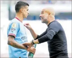  ?? ?? João Cancelo y Pep Guardiola, esta temporada.