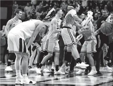  ?? BOB DONNAN/USA TODAY SPORTS ?? UMBC Retrievers players celebrate after they defeated the Virginia Cavaliers in the first round of the NCAA Tournament at Spectrum Center in Charlotte, N.C., on Friday.