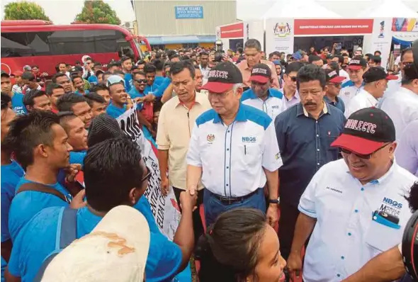  ?? PIC BY FARIZUL HAFIZ AWANG ?? Prime Minister Datuk Seri Najib Razak being greeted by participan­ts at the Fiesta National Blue Ocean Strategy programme in Padang Kampung Baru Salong, Pekan, yesterday.