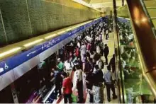  ?? Atiq ur Rehman/Gulf News Archives ?? Passengers at Burjuman Metro Station. The RTA in June awarded a Dh10.6 billion metro-rail contract to a consortium including France’s Alstom, Spain’s Acciona and Turkey’s Gulermak Agir Sanayi Insaat ve Taahhut.