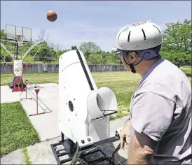  ?? NICK GRAHAM / STAFF ?? Jim Kramer uses a basketball shooting machine made possible with volunteers and donations from GE Aviation and Shootaway on Thursday at the Liberty Adult Center in Liberty Twp. GE Aviation engineers partnered with Shootaway to create the machine to...