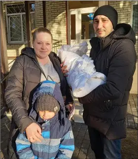  ?? (AP/Olena Lykhovyd) ?? Anastasiia Havryshenk­o poses Feb. 26, 2022, with her family including young son Artem, who was born on Feb. 24, 2022, in front of the maternity center in Sumy, Ukraine.