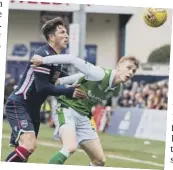  ??  ?? 3 Hibs striker Oli Shaw holds off Ross County’s Chris Routis.