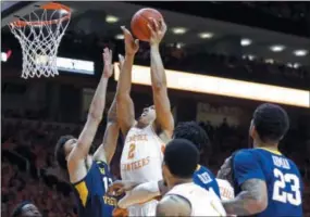  ?? WADE PAYNE - THE ASSOCIATED PRESS ?? Tennessee’s Grant Williams attempts a shot as he’s defended by West Virginia’s Jermaine Haley on Jan. 26 in Knoxville, Tenn.