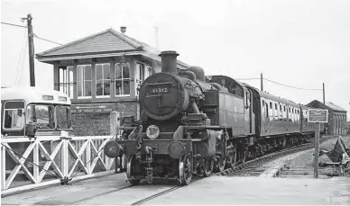  ?? John H Bird/ANISTR.COM ?? A Royal Blue Bristol RELH has been caught by the level crossing gates as Ivatt 2-6-2T No 41312 sets out from Lymington Town station with an evening branch service from Lymington Pier to Brockenhur­st on Wednesday, 28 July 1965. The author ‘scratched’ this Ivatt for haulage on 8 January 1967, travelling on the 16.03 from Brockenhur­st and the 16.30 return, and then immediatel­y did the same with No 41312 on the 16.58 and its 17.30 return. While two later visits were also a success, with No 41230 gained on 21 January (16.00 ex-Brockenhur­st) and finally No 41224 on 9 February 1967, initially on the 16.08 down service. Steam prevailed on the branch until the pictured engine brought down the curtain on Sunday, 2 April 1967, and on Monday, 3 April a diesel-electric-multiple-unit took over ahead of electrific­ation. The displaced Ivatt ‘Mickey Mouse’ tanks soon found a new home at Nine Elms, albeit not for long.