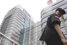  ?? — Reuters ?? A security guard walks past a building of ZTE Beijing research and developmen­t centre in Beijing, China.