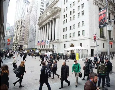  ?? NORMAN/THE NEW YORK TIMES BENJAMIN ?? Outside the New York Stock Exchange building the morning after Donald Trump won the presidenti­al race, in New York, on November 9. Though stocks have risen 5 percent since Trump took office, some hedge fund managers are bracing for a sell-off.