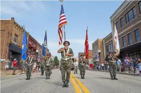  ?? Steve Mellon/Post-Gazette ?? Members of Vietnam Veterans of America Southweste­rn Pennsylvan­ia Chapter 862 present flags oduring the Midland Fourth of July parade on July 4, 2021.