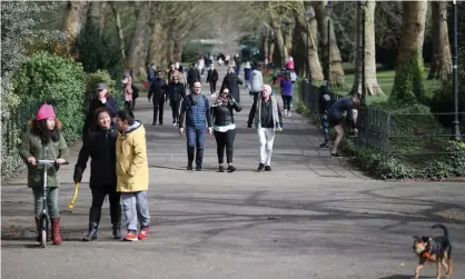  ?? Photograph: Hannah McKay/Reuters ?? Too close for comfort ... crowds in Battersea Park, London, on 21 March.