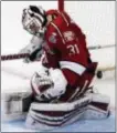  ?? NAM Y. HUH — THE ASSOCIATED PRESS ?? Harvard goalie Merrick Madsen, a Flyers draft pick, can’t stop a goal by Minnesota-Duluth left wing Alex Iafallo during the third period Thursday in Chicago. Minnesota-Duluth won 2-1.