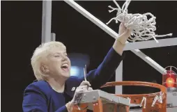  ?? AP FILE PHOTO ?? Penn State women’s basketball coach Rene Portland waves the net she cut down to celebrate their 2003 Big 10 regular season championsh­ip after defeating Wisconsin in State College, Pa.