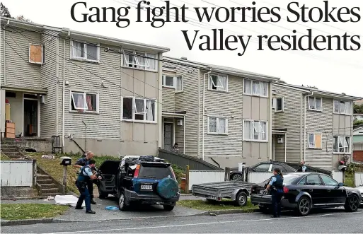  ?? THOMAS MANCH/STUFF ?? Armed police officers search vehicles after a gang brawl in the Lower Hutt suburb of Stokes Valley yesterday.