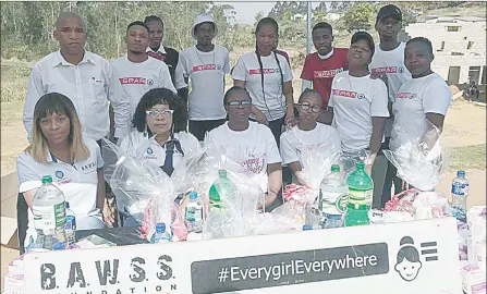  ?? (Pic: Setsabile Nkambule) ?? Mbabane Spar employees, together with representa­tives from the BAWSS Foundation, during the presentati­on of the sanitary towels donated by Spar.