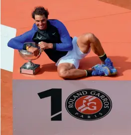  ??  ?? Rafael Nadal poses with the trophy in Paris on Sunday.