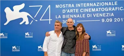  ??  ?? Director Samuel Maoz, center, and actors Lior Ashkenazi, left, and Sarah Adler pose during the photo call for the film “Foxtrot”.