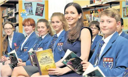  ??  ?? ●● Author Emily Hauser with pupils from King’s School