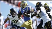  ?? KELVIN KUO — THE ASSOCIATED PRESS ?? UCLA running back Brittain Brown, center, runs the ball for a touchdown past California safety Daniel Scott, left, and Elijah Hicks, Nov. 15. UCLA won 34-10.