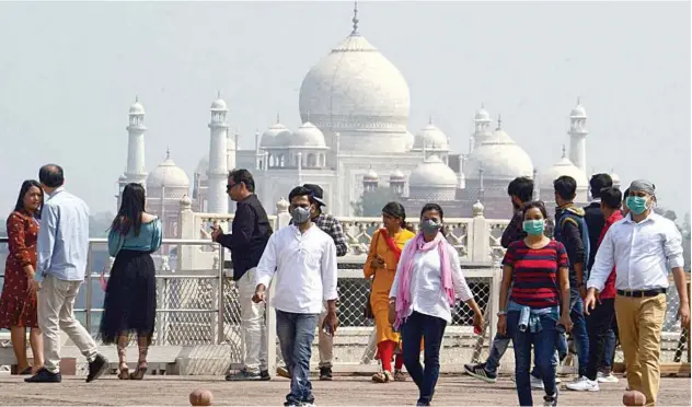  ?? Agence France-presse ?? Tourists wear facemasks as a preventive measure against the spread of COVID-19 coronaviru­s outbreak near Taj Mahal in Agra on Thursday.