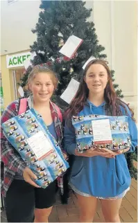  ??  ?? THE JOY OF GIVING: Port Alfred High School pupil, Julia Stanford, right, and her friend, Sage Botha went shopping at Rosehill Mall using a Rotary Tree of Joy card and returned with gifts for two local children in need. The Tree of Joy is an annual...