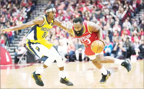  ?? (AP) ?? Houston Rockets’ James Harden (13) drives toward the basket as Indiana Pacers’ Justin Holiday (8) defends during the second half of an NBA basketball game on Nov 15, in Houston. The
Rockets won 111-102.