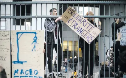  ?? Picture: EPA ?? BROTHERHOO­D. French students post a banner reading ‘Solidarity with foreigners’ on the Tolbiac University fence after a blockade was decided during a general assembly, in Paris, France.