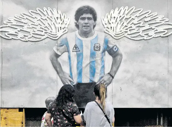  ?? ?? Ein Kunstwerk vor einem Lokal in Buenos Aires. Diego Maradona hat Flügel aus Neonlichte­rn bekommen.