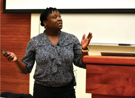  ?? (Pine Bluff Commercial/I.C. Murrell) ?? Samaiyah Farid, a heliophysi­cist, delivers a presentati­on called “Chasing Darkness: Observing Rare Total Solar Eclipse on April 8, 2024,” at the UAPB 1890 Extension Building Haley Auditorium on Thursday.