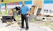  ?? Pin Lim / For the Chronicle ?? Oli Mohammed of Houston Furniture Bank stands outside the burnt warehouse.