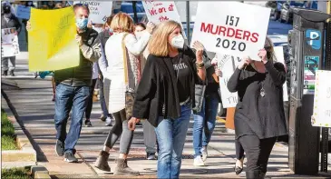  ?? STEVE SCHAEFER/ FOR THE AJC ?? A group marches Monday around City Hall, protesting against the rise in Atlanta homicides in 2020. One protester who is a mom said she does not allow her children to go to the mall anymore.