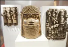  ?? IEL BOCKWOLDT/DPA VIA AP
DAN- ?? Three pieces of Benin Bronzes are displayed at Museum for Art and Crafts in Hamburg, Germany, Feb. 14, 2018. Germany is returning hundreds of artifacts known as Benin Bronzes that were mostly looted from western Africa by a British colonial expedition and subsequent­ly sold to collection­s around the world, including German museums.