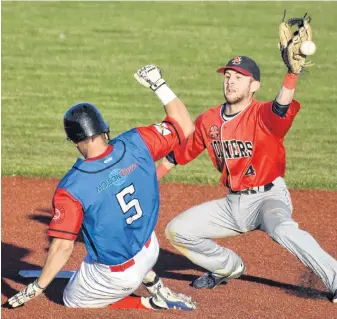  ?? JEREMY FRASER/CAPE BRETON POST ?? Chris Farrow of the Sydney Sooners, right, and Greg MacKinnon of the Halifax Pelham Canadians during a Nova Scotia Senior Baseball League game in Sydney, last summer. Baseball players will soon return to the field but they will have to follow a COVID-19 rule book.