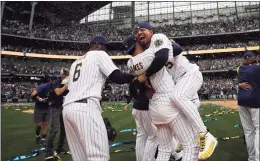  ?? Aaron Gash / Associated Press ?? The Brewers’ Eduardo Escobar, right, hugs Willy Adames after defeating the Metson Sunday in Milwaukee to clinch the NL Central.