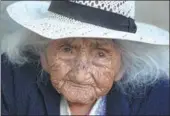  ?? JUAN KARITA / ASSOCIATED PRESS ?? Julia Flores Colque sits outside her home in Sacaba, Bolivia. Her national identity card says she was born on Oct 26, 1900 in a mining camp in the Bolivian mountains.