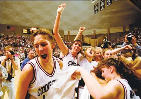  ?? John Dunn / Associated Press ?? UConn’s Rebecca Lobo, left, cheers as she runs off the floor after No. 2 Connecticu­t defeated top-ranked Tennessee in Storrs in 1995. Behind Lobo is teammate Kara Wolters, and at right is Jennifer Rizzotti.