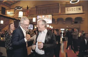  ?? Carolyn Cole Los Angeles Times ?? DISTRICT ATTORNEY hopeful George Gascón, left, greets backers Tuesday at Union Station as they await results. Gascón gained ground with each wave of updates, and by Wednesday night he stood at about 27%.