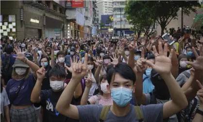  ?? Photograph: Vincent Yu/AP ?? People protesting in Hong Kong in July against the national security law gesture with their fingers signifying their ‘Five demands – not one less’.