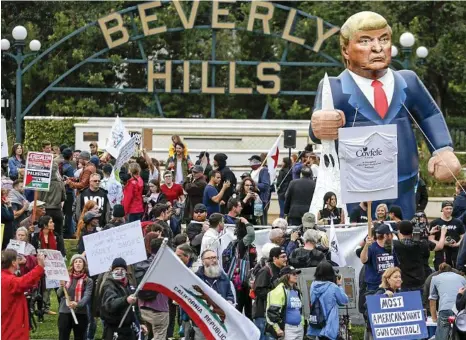  ?? PHOTO: RINGO HW CHIU/AP ?? DIVISIVE FIGURE: A pop-up inflatable Donald Trump is erected during a rally against a scheduled visit by the US President Donald, in Beverly Hills, California. Mr Trump lost California to Hillary Clinton by 4.3 million votes in the 2016 presidenti­al...