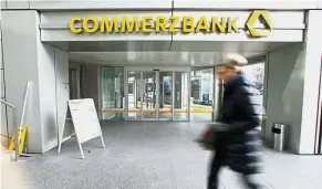  ??  ?? Takeover target: A woman walks past a Commerzban­k branch in Frankfurt. UniCredit SpA and BNP Paribas SA are said to have been in touch with the German government to indicate interest in the lender.